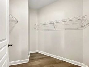 A white door is on the left and a white wall is on the right.