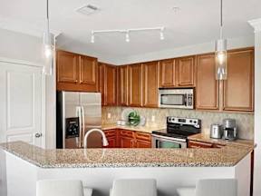 A kitchen with wooden cabinets and a granite countertop.