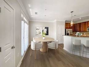 A modern kitchen with a dining table and chairs.