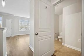 A white door is open to a bathroom.