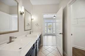 A bathroom with a white sink and a mirror above it.
