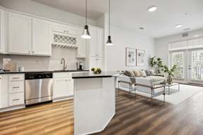 A modern kitchen with white cabinets and a large island.