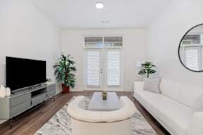 A living room with a television, a couch, and a coffee table.