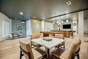 A modern dining room with a large table and chairs.