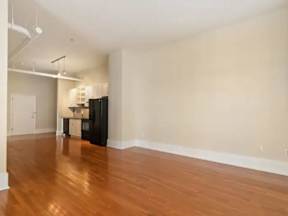 A room with wooden floors and white walls.