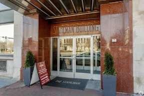 The entrance to the Silverman Building with a sign on the ground.