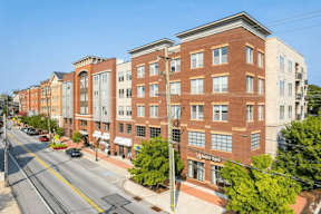 A street view of a city with a building that has a sign that says