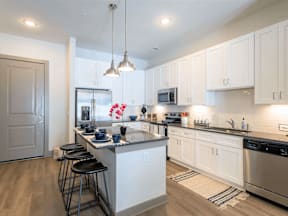 A kitchen with a bar area and a fridge.