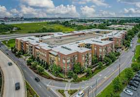 A large building complex with a parking lot in front.