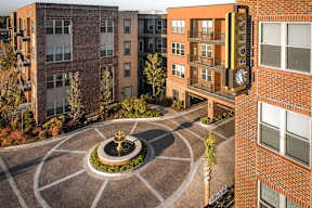 A courtyard with a fountain in the middle of it.