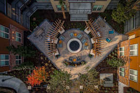 A courtyard surrounded by buildings with a circular design in the middle.