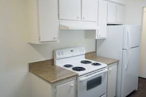 an all white kitchen with white appliances and white cabinets