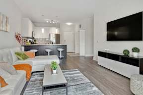 Open concept living room with kitchen and bar seating at Arden of Oak Brook Apartments, Oakbrook Terrace