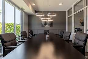 Boardroom with modern chandelier and executive seating at Arden of Oak Brook Apartments, Illinois