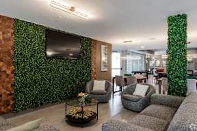 Community lounge with living wall and modern seating at Arden of Oak Brook Apartments, Oakbrook Terrace, IL 60181