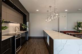 Modern kitchen with dark cabinetry and marble backsplash at Arden of Oak Brook Apartments, Oakbrook Terrace, 60181