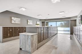 Mail room with package lockers and service counter at Arden of Oak Brook Apartments, Oakbrook Terrace, Illinois