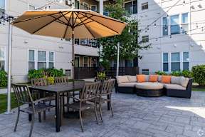 Outdoor patio with sectional sofa and dining table at Arden of Oak Brook Apartments, Oakbrook Terrace, IL