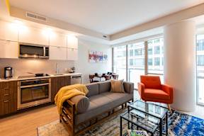 couch with wooden cabinets at Artline Apartments, Washington, DC