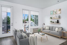 1 BR Apartments in Southeast Portland, OR - The Lenox - Living Room with Stylish Decor, Luxury Wood Grain Vinyl Plank Flooring, Large Windows, and Door to Balcony