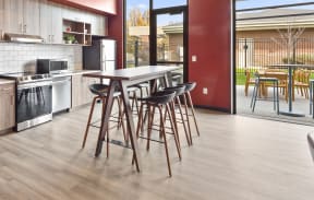 a kitchen with a table and chairs in front of a window