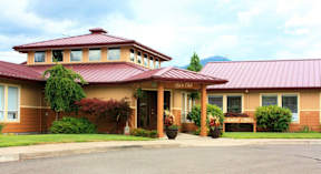 A building with a red roof and a sign that says "River Glen".
