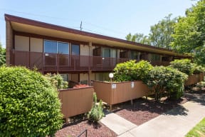 the front of a house with a deck and a garden