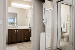 A bathroom with a white toilet and a white sink.