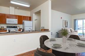 A kitchen with brown cabinets and a white fridge.