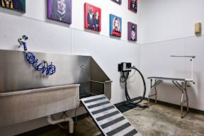 a gas pump and bench in a room with pictures on the wall