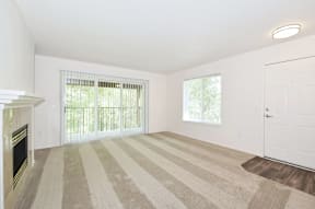 A room with a fireplace and striped carpet.