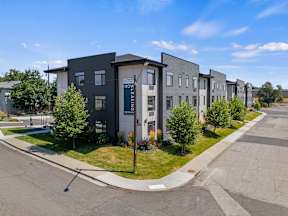 exterior corner view of the modern apartments Flats on Liberty with a sidewalk surrounding