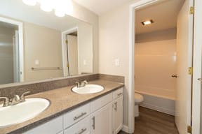 A bathroom with a sink, mirror, and toilet.