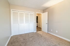 A room with a carpeted floor and white walls.