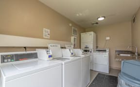 A laundry room with washers and dryers.