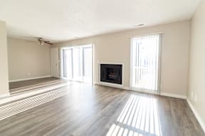 A living room with a fireplace and sliding glass doors.