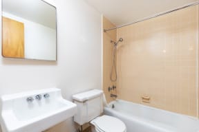 a bathroom with a sink toilet and a bath tub