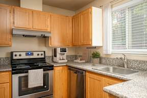 A kitchen with wooden cabinets and a stove top oven.
