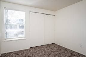 A room with a window and a sliding door.