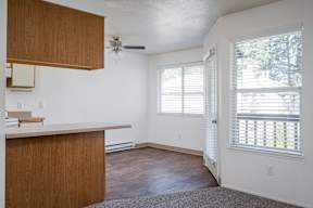 A room with a wooden counter and a ceiling fan.