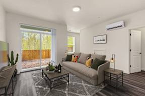 A living room with a grey couch and a coffee table.