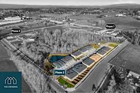 An aerial view of a construction site with three phases of development.