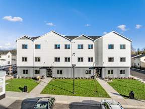 A large white apartment building with the word