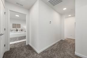 A room with white walls and carpeted floor.