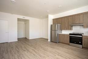 A kitchen with wooden cabinets and a refrigerator.