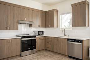 A kitchen with wooden cabinets and stainless steel appliances.