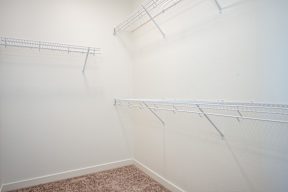 Empty room with white walls and shelves.