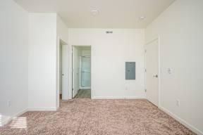 A room with a carpeted floor and white walls.