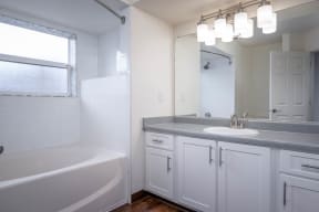 Village at Main Street | 2x2 Bedroom One Bathroom with White Cabinetry and Large Mirror
