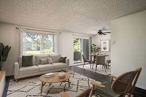 A living room with a couch, a chair, a table, and a ceiling fan.